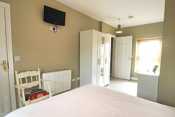 Luxury bedroom with double bed and TV
